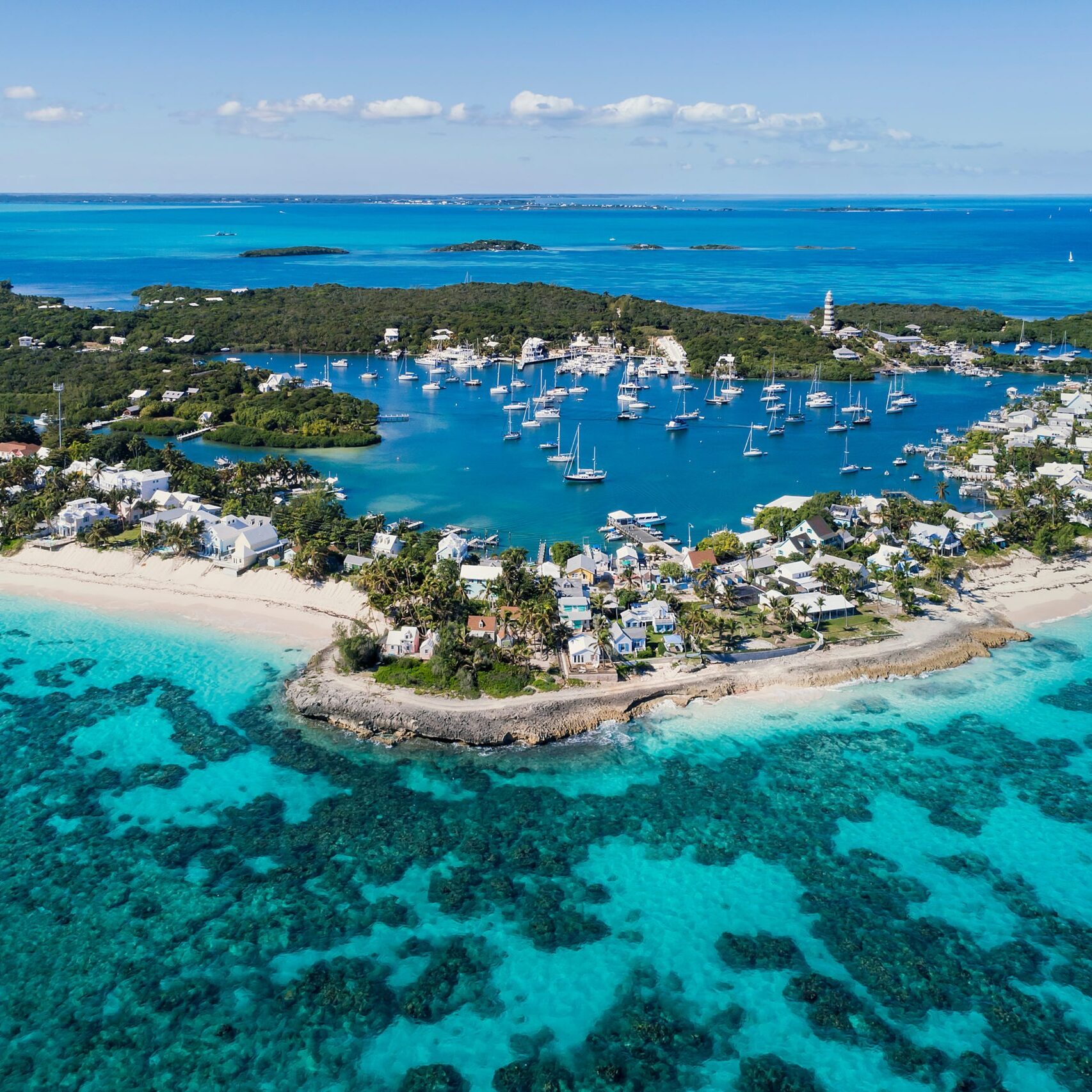 Aerial view of the harbour, beach and lighthouse in Hope Town on Elbow Cay off the island of Abaco, Bahamas.